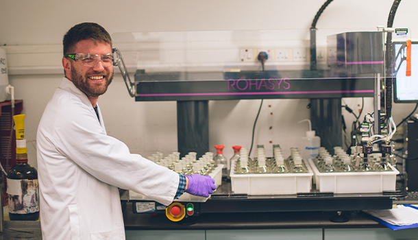 Wessex Water scientist smiling whilst working in the lab