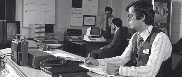 Black and white image of a Wessex Water employee working in an office from the 70s