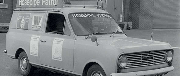 Black and white photo of an old hosepipe ban van on patrol